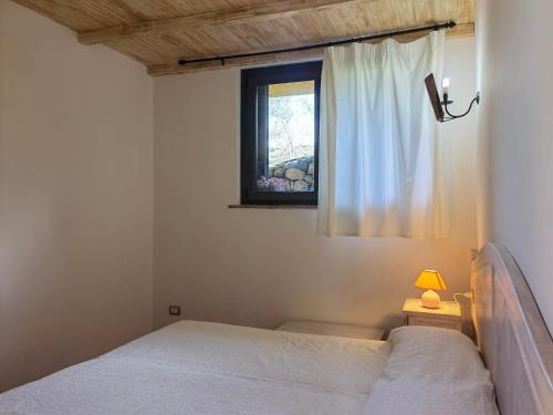 a bedroom with two beds and a window at La Corte degli Ulivi - Albergo Rurale in Tresnuraghes