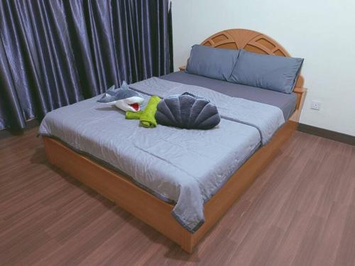 a bed with a stuffed animal on top of it at IJM Homestay Condominium in Sandakan