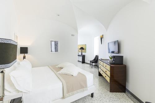 Postel nebo postele na pokoji v ubytování Roccobarocco Boutique Hotel
