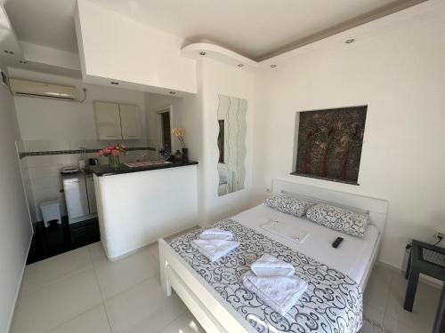 a bedroom with a white bed with two towels on it at Accommodation Tomcuk in Kotor