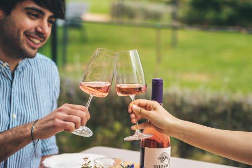 two people holding up wine glasses at a table at Podere Montale Il Borgo in Seggiano