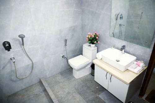 a bathroom with a shower and a toilet and a sink at Divine India Service Apartment 3Bhk, 2B Saket in New Delhi