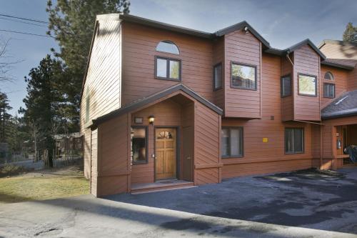 a large wooden house with a wooden door at Mammoth Village Properties by 101 Great Escapes in Mammoth Lakes