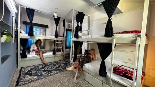 a group of people sitting on bunk beds in a room at Dreamyard Udaipur in Udaipur