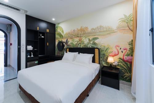 a bedroom with a large bed with a painting on the wall at Q Boutique Hotel in Nha Trang