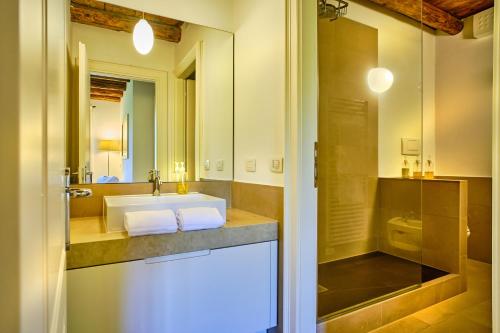 a bathroom with a sink and a mirror at Relais Corte Guastalla Apartments in Sona