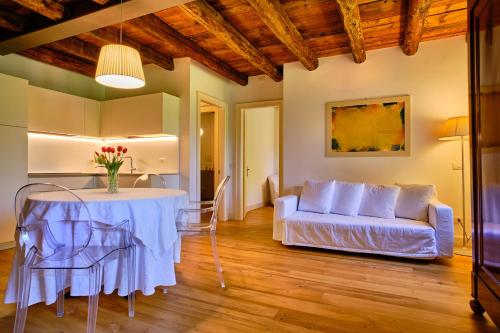 a living room with a table and a couch at Relais Corte Guastalla Apartments in Sona