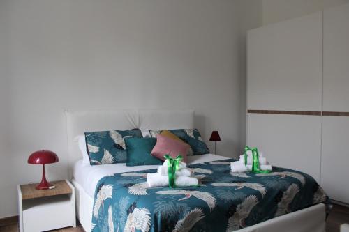 a bedroom with a bed with a blue and white comforter at Albadamar Terrace in Trani