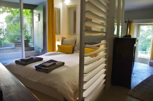 a bedroom with a bed with two towels on it at Nature calme piscine privée chauffée 7 jours minimum in Brullioles