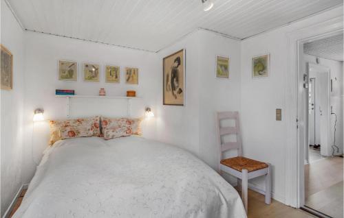 a white bedroom with a bed and a chair at Beautiful Home In Grlev With Wifi in Gørlev