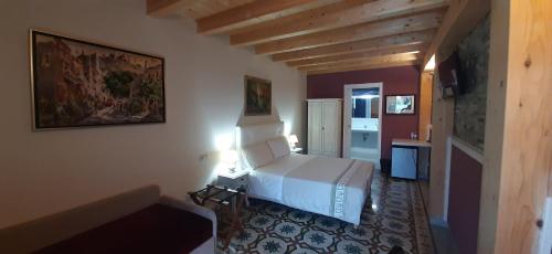 a bedroom with a white bed in a room at Al Castello in Milazzo