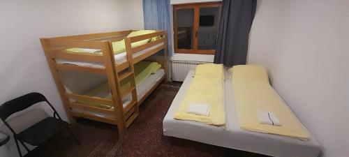 a small room with two bunk beds and a window at Mahala Guesthouse in Sarajevo