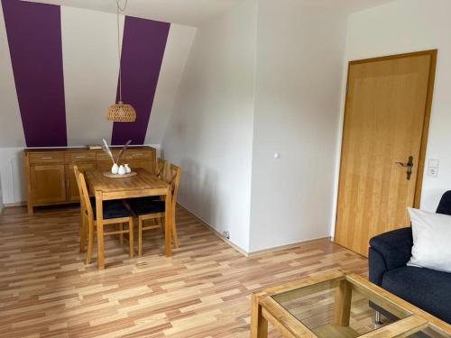 a living room with a table and a couch at Ferienwohnung Friedrich Dorfmark in Bad Fallingbostel