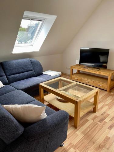 a living room with a couch and a coffee table at Ferienwohnung Friedrich Dorfmark in Bad Fallingbostel