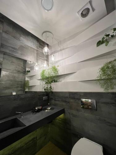 a bathroom with a sink and a toilet at Blum Hotel in Lviv
