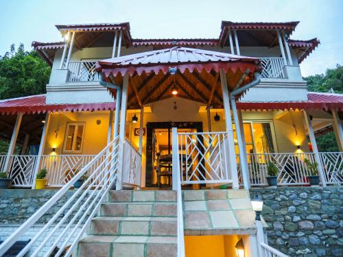 a house with a staircase leading to the front door at Vibhasa-The Scenic Solitude Villa Amidst Himalayas Near Kainchi Dham-Where BBQ and Bonfires Ignite the Adventure in Rāmgarh