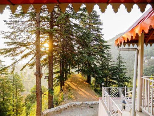a view from the porch of a house with a view of a road at Vibhasa-The Scenic Solitude Villa Amidst Himalayas Near Kainchi Dham-Where BBQ and Bonfires Ignite the Adventure in Rāmgarh