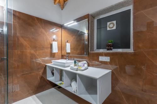 a bathroom with a sink and a mirror at Vibhasa-The Scenic Solitude Villa Amidst Himalayas Near Kainchi Dham-Where BBQ and Bonfires Ignite the Adventure in Rāmgarh