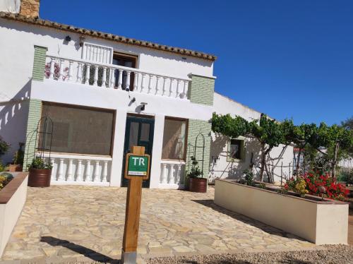 ein weißes Haus mit einem Schild davor in der Unterkunft Casa de Bello in Tortosa