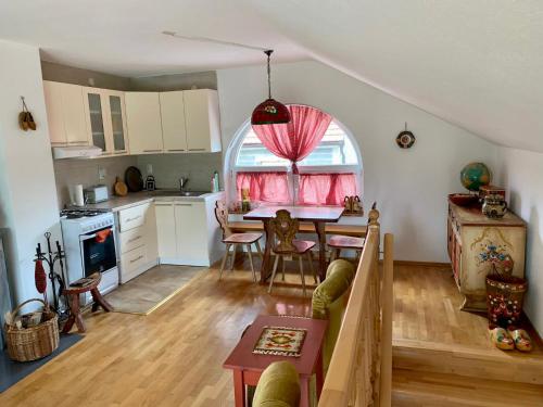 a kitchen and dining room with a table and a window at Sokograd Attic in Šipovo
