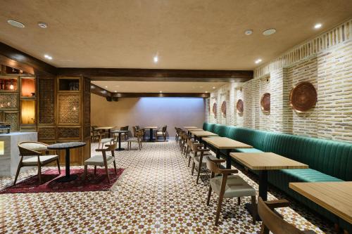 a row of tables and chairs in a restaurant at Kosh Havuz boutique hotel in Samarkand