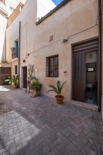 a building with a door and plants in front of it at Si-Moutique, le Case-grotte degli Avi 2 in Modica