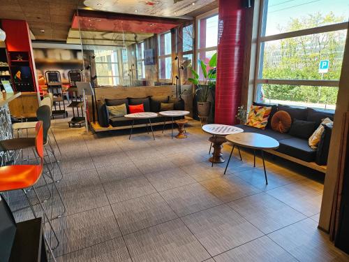 a store with tables and couches in a room at ibis Genève Aéroport in Geneva