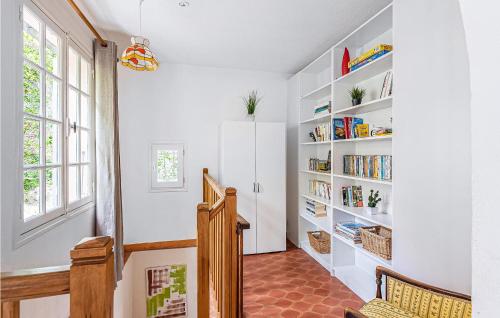 a hallway with white bookshelves and a staircase at Amazing Home In Les Adrets-De-L'estére in Les Adrets de l'Esterel