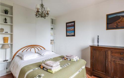 a bedroom with a bed and a chandelier at Amazing Home In Les Adrets-De-L'estére in Les Adrets de l'Esterel