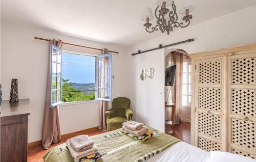 a bedroom with a bed and a large window at Amazing Home In Les Adrets-De-L'estére in Les Adrets de l'Esterel