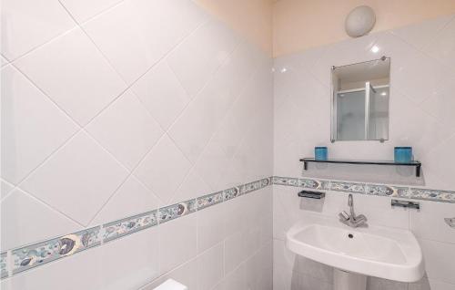 a white bathroom with a sink and a mirror at Amazing Home In Les Adrets-De-L'estére in Les Adrets de l'Esterel