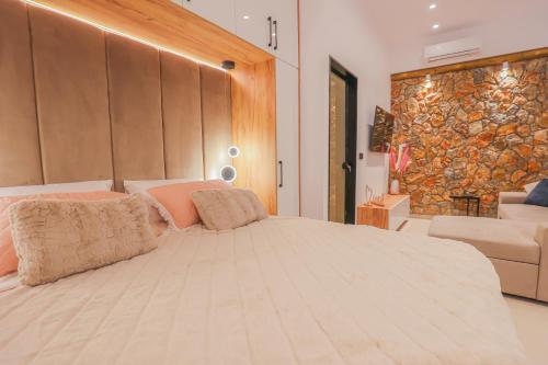 a bedroom with a large bed and a couch at City Compass Luxury Villa in Faliraki