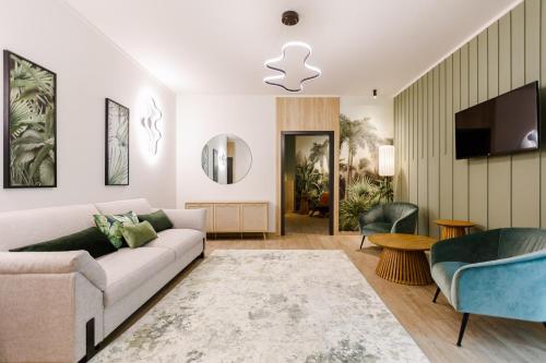 a living room with a couch and a tv at Amazonia Hotel in Timişoara