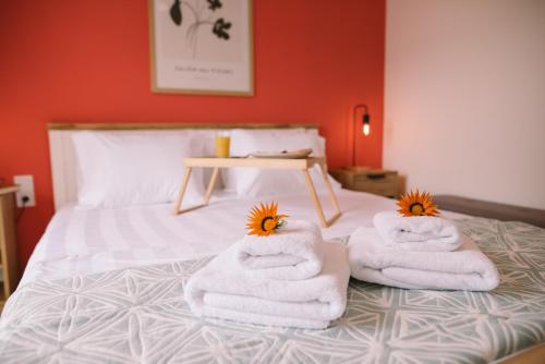 a bed with towels and flowers on top of it at NIOUVOLA 11 in Ioannina