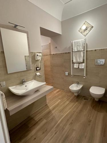 a bathroom with a sink and a toilet and a mirror at Maera B&B Ravello in Ravello