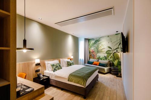 a hotel room with a bed and a couch at Amazonia Apartments in Timişoara