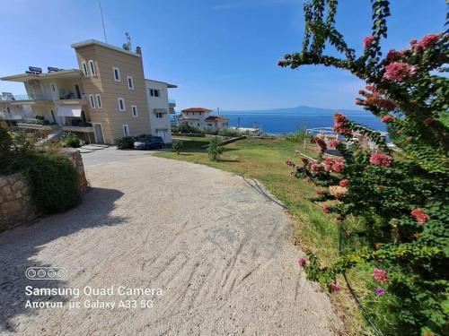 a road in front of a house with the ocean at Lovely Stay in Kalamata