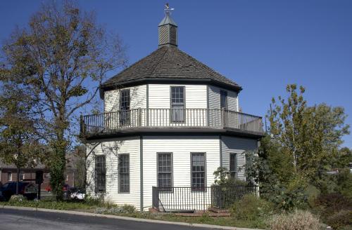 an old white building with a tower on top of it at Century Suites Hotel in Bloomington