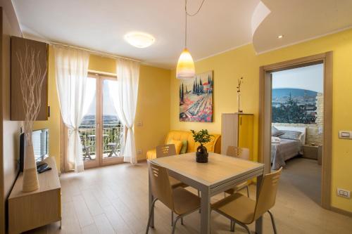 a dining room and living room with a table and chairs at Holiday Residence Belohorizonte in Macerata