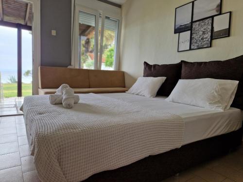 a bedroom with a bed with a stuffed animal on it at On the wave studios Spitakia sto kyma in Nikiti