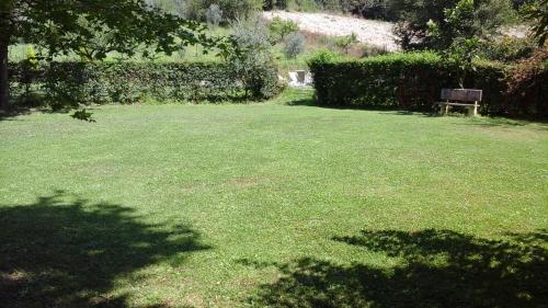 a park with a bench in the middle of a yard at Cascina Gretaio, dimora tipica in Reggello