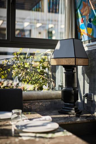 a lamp sitting on a table in front of a window at Hôtel particulier Le DOGE - Relais & Châteaux in Casablanca