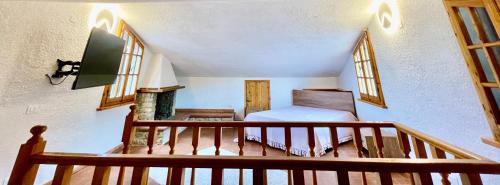 a room with a staircase with a bed and windows at Le Vecchie Cantine in Chianni