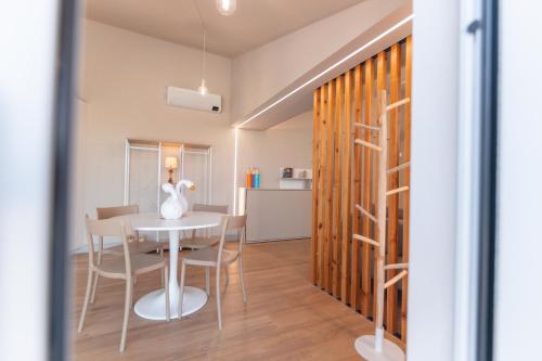 a dining room and kitchen with a table and chairs at Ca' del magu in San Michele Mondovì