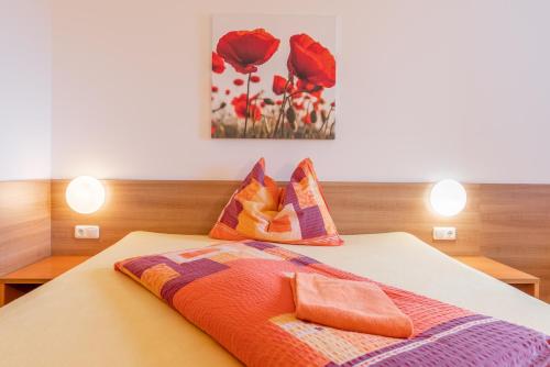 a bedroom with a bed with two pillows on it at OEKOTEL Treffpunkt Föhrenhain in Föhrenhain