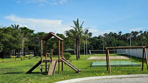 a park with a playground with a swing set at Lençóis Confort - Apartamento in Barreirinhas