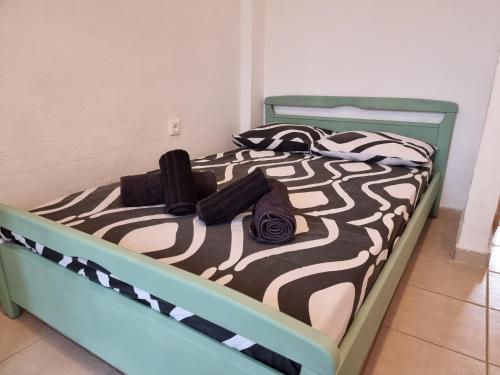 a bed with a zebra print comforter on it at Sunny House in Perea