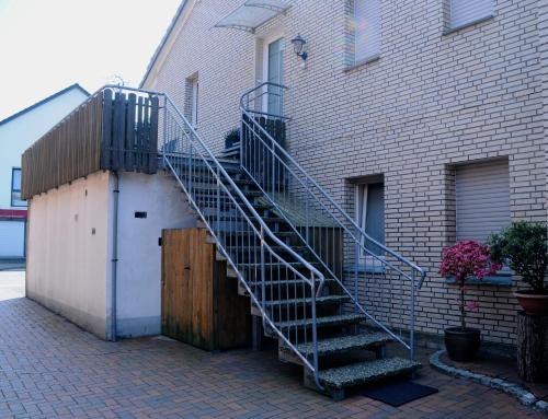 a metal staircase leading up to a building at Bonsai-Ferienwohnung in Bad Laer