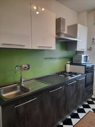 a kitchen with a sink and a stove at Siore Marie gli alloggi in San Giórgio di Nogaro