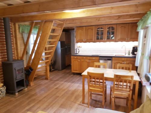 a kitchen with a table and chairs and a staircase at U Toma in Malá Morávka